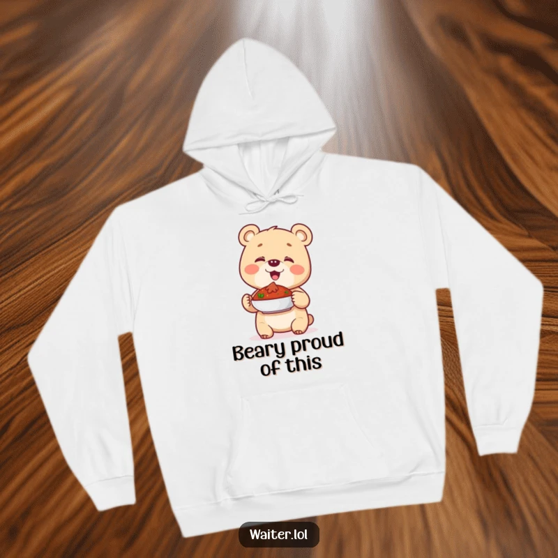 Funny hoodie showcasing a giggling bear cub presenting a dish with a proud, happy gesture, perfect for cozy laughs.