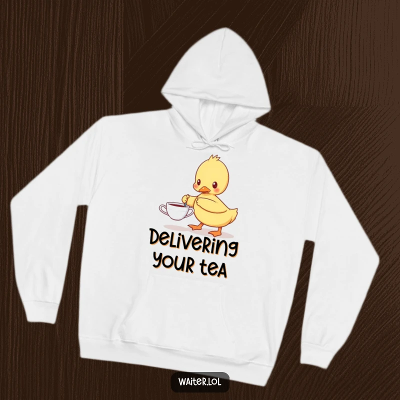 Funny hoodie featuring a determined duckling carefully carrying a single teacup, offering warmth and a dose of adorable humor.