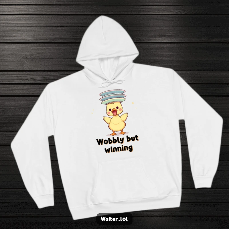 Funny duckling hoodie, gleefully balancing a tall stack of plates on its head, radiating pure, comical joy.
